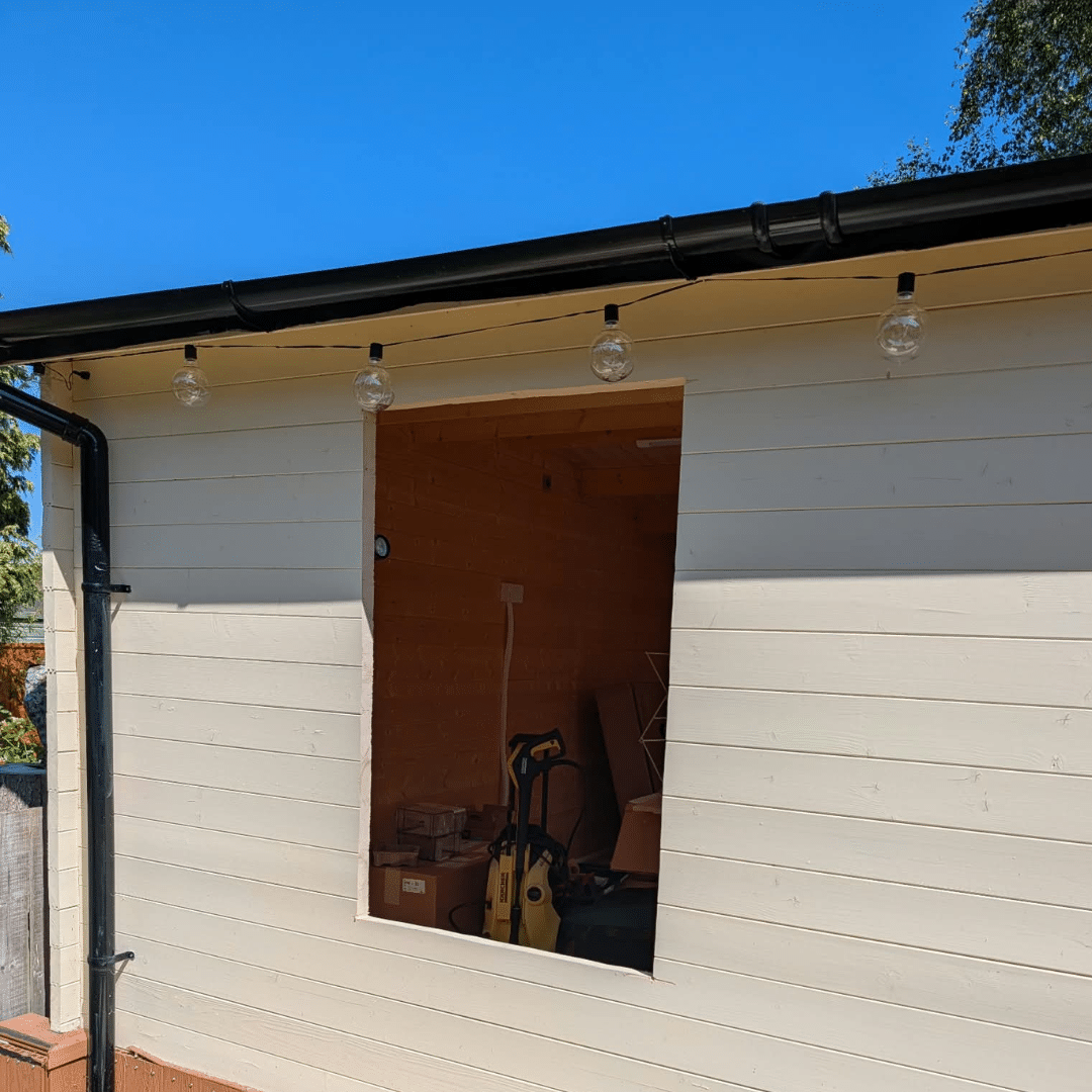 New window opening cut into outside of log cabin in Hempstead Medway