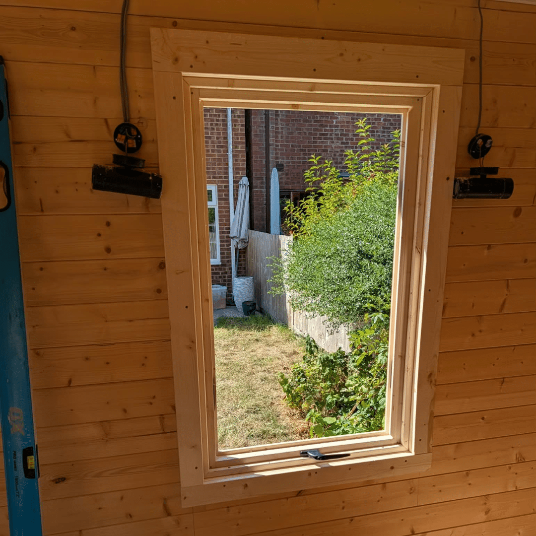 Finished inside view of log cabin window installation in Hempstead Medway
