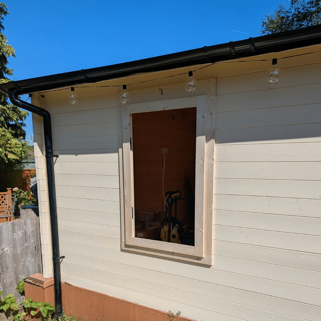 Finished outside view of log cabin window installation in Hempstead Medway